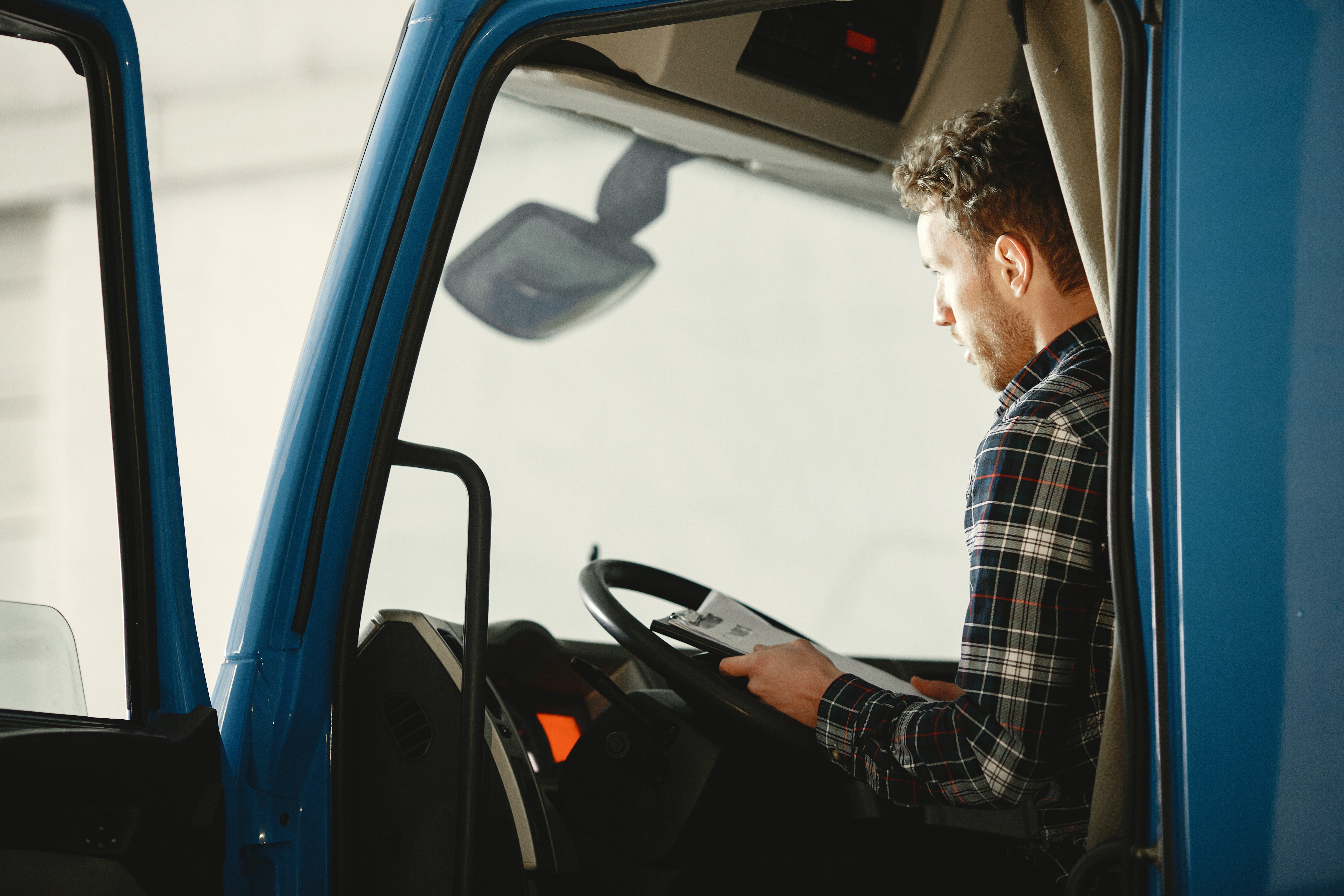 Man in truck holding documents